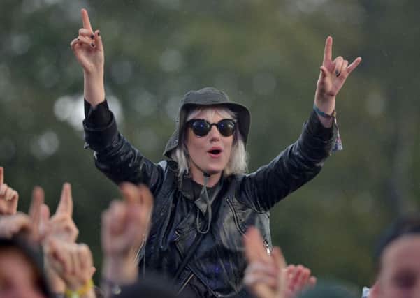 A festival goer watches Vampire Weekend perform during day two of the Leeds Festival in Bramham Park.