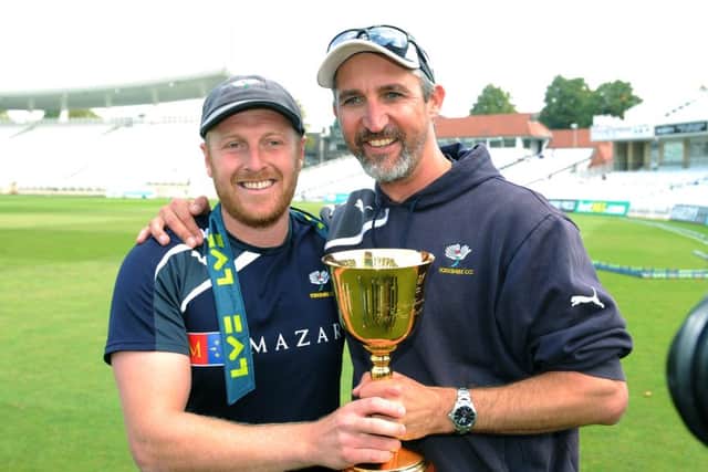 CHAMPIONS: Jason Gillespie, right, and captain Andrew Gale celebrate after winning the County Championship. Picture: Jonathan Gawthorpe.