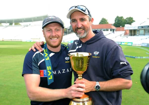 CHAMPIONS: Jason Gillespie, right, and captain Andrew Gale celebrate after winning the County Championship. Picture: Jonathan Gawthorpe.