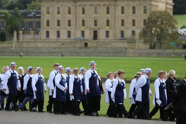 Chatsworth House staff walk into position along the route leading to the Church. The funeral for the Dowager Duchess of Devonshire at Chatsworth House today October 2 2014. Over 600 staff and thousands of public lined the drive leading to Chatsworth House to pay their respects to the Dowager. Tom Maddick / Rossparry.co.uk