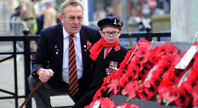 Six-year-old Harvey Roberts with his great-grandad Bill Ramsey look at the wreaths at the annual Leeds Remembrance Sunday service