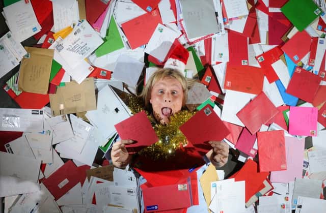 Lisa Jackson from Swillington, Leeds, among the Christmas letters at the Royal Mail sorting office. Pictures by Simon Hulme