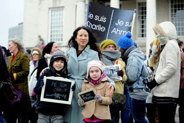 Date:  11th January 2015, (JH1006/80f) Charlie Hebdo vigil organised by French journalist Mireille Mason-Beguin, marching down Briggate, Leeds. Pictured Catherine Bailey, with her two children Orlando, 7, and Olivia, 5.