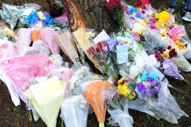 Some of the floral tributes left at the scene of the crash