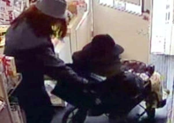 One of the robbers pushes the other in a wheelchair