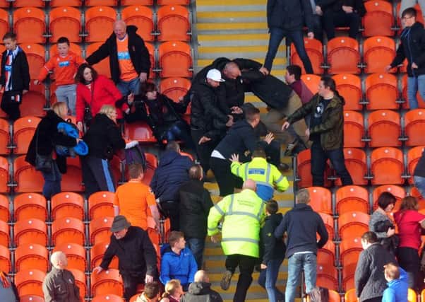 Trouble flares up behind the goal in  the Blackpool end.  Picture by Tony Johnson
