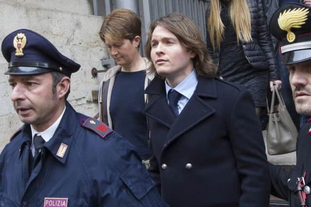 Raffaele Sollecito, center,  leaves Italy's highest court building with his girlfriend Greta Menegaldo