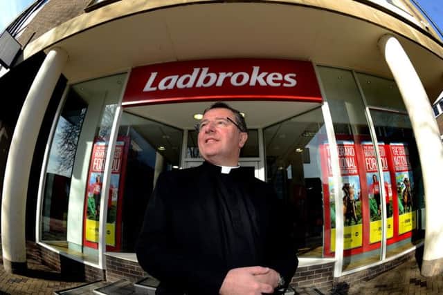 The Dean of Wakefield, the Very Rev Jonathan Greener, outside the Ladbrokes shop neighbouring Wakefield Cathedral.