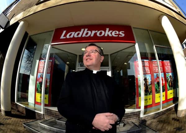 The Dean of Wakefield, the Very Rev Jonathan Greener, outside the Ladbrokes shop neighbouring Wakefield Cathedral.