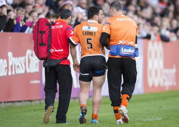 Picture by Allan McKenzie/YWNG - 11/04/2015 - Rugby League - First Utility Super League - Castleford Tigers v Hull Kingston Rovers - The Mend A Hose Jungle, Castleford, England - Castleford's Justin Carney is helped off after injuring himself against Hull KR.