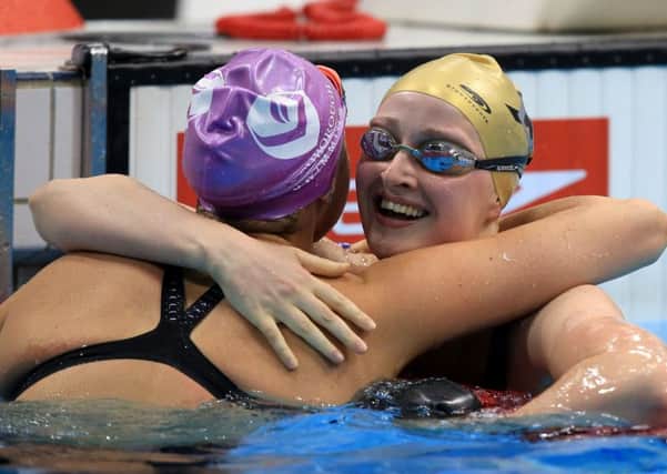Sarah Vasey, (right) celebrates her second place finish in the women's 100m breaststroke final with Molly Renshaw, (left).