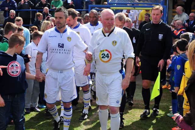 Former Leeds player Gary Kelly walks on to the pitch with Brendan Ormsby