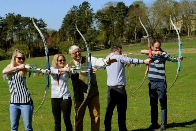 Terri-Ann Prendegast (left) tries her hand at archery alongside others during a preview day for the CLA Game Fair at Harewood House.
