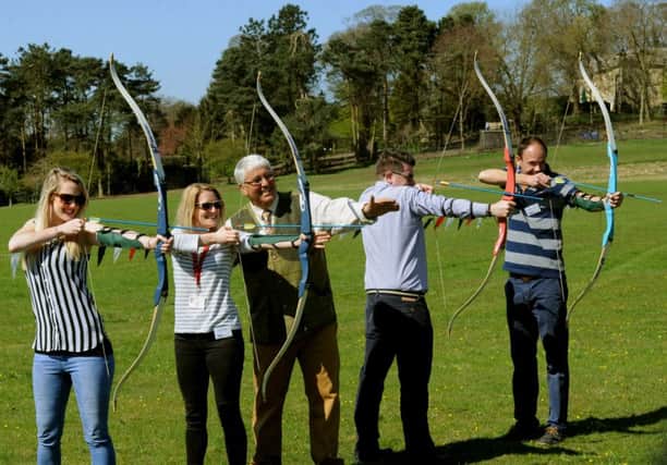 Terri-Ann Prendegast (left) tries her hand at archery alongside others during a preview day for the CLA Game Fair at Harewood House.