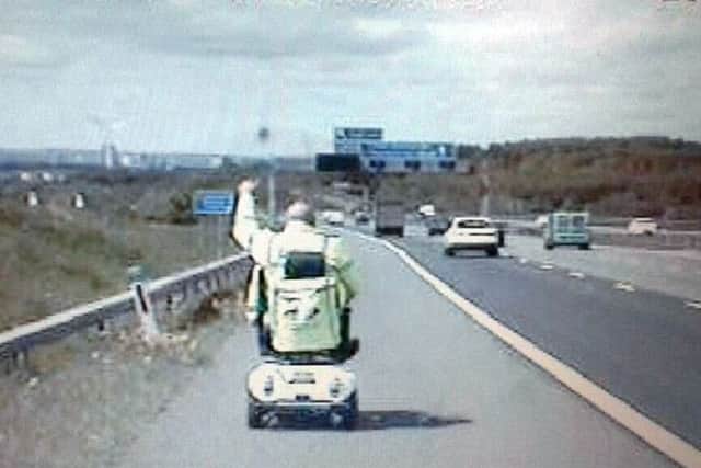 PC Smith of West Yorkshire Police's Roads Policing Unit drives the scooter on the M1