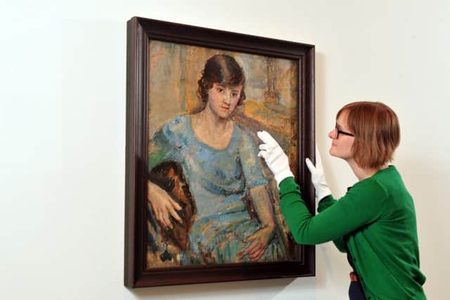 Curator Eleanor Clayton with the portrait of the young Barbara Hepworth. Picture by Tony Johnson