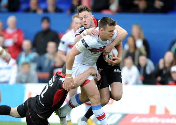 Wakefield's Joe Arundel is tackled by Leigh's Ryan Brierley and Tommy Goulden.