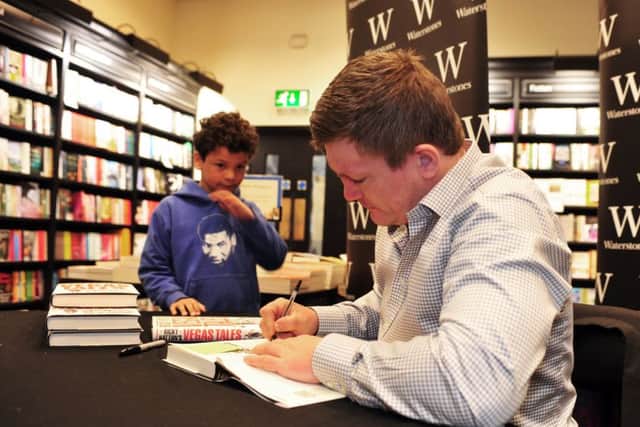 Ricky Hatton signs copies of his new book  Ricky Hattons Vegas Tales' for a young fan at Waterstones, in Albion Street, Leeds. Picture by Tony Johnson.