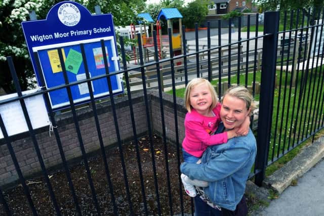 Lucy Clement, Fair Access campaigner celebrating with daughter Daisy outside Wigton Moor Primary School. Picture Jonathan Gawthorpe.