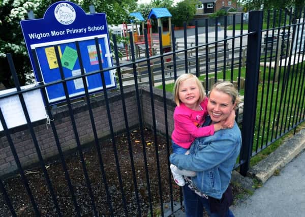 Lucy Clement, Fair Access campaigner celebrating with daughter Daisy outside Wigton Moor Primary School.  Picture Jonathan Gawthorpe.