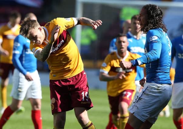 FLASHPOINT: Leeds United target Lee Erwin, of Motherwell, left, clashes with Rangers defender Bilel Mohsni. Picture by Andrew Milligan/PA Wire.