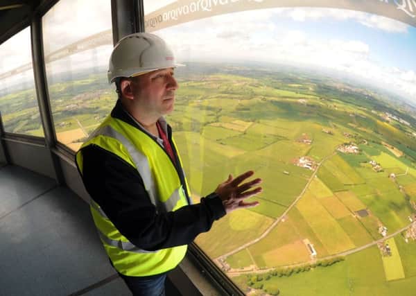 Steve Megyery pictured at the top of Emley Moor mast