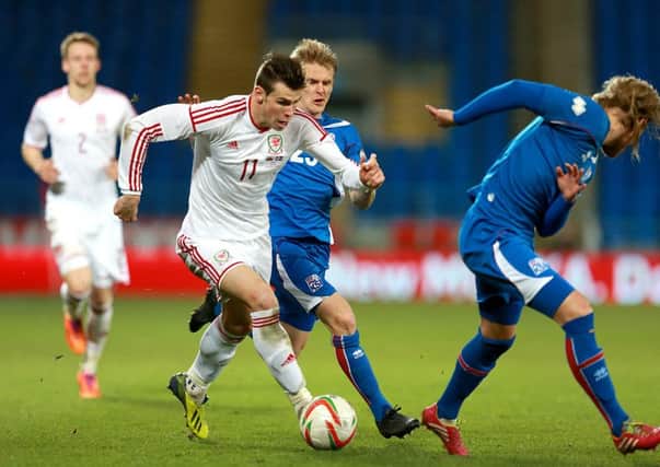 Wales' Gareth Bale (left) takes on Iceland's Ari Freyr Skulason (centre) and Birkir Bjarnason.