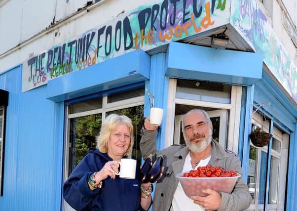 Volunteers Ann Shelley and Nigel Stone outside the Armley Junk-tion cafe