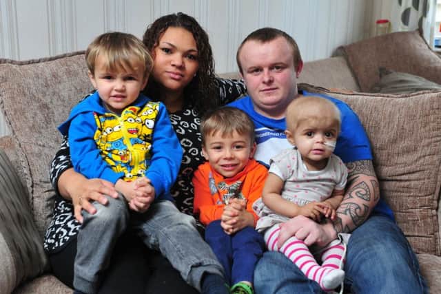 Amie Mills and Damion Sutcliffe with their children Harvey, Riley and Skye. Picture by Tony Johnson.