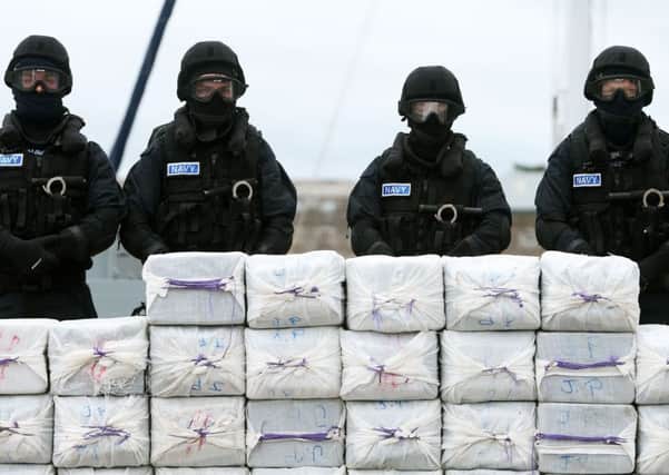Members of the navy stand behind what is believed to be cocaine