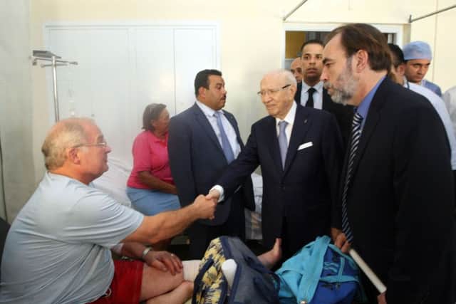 Tunisian President Beji Caid Essebsi, 2nd right, visits a survivor of a terrorist attack in an hospital in the costal town of Sousse.