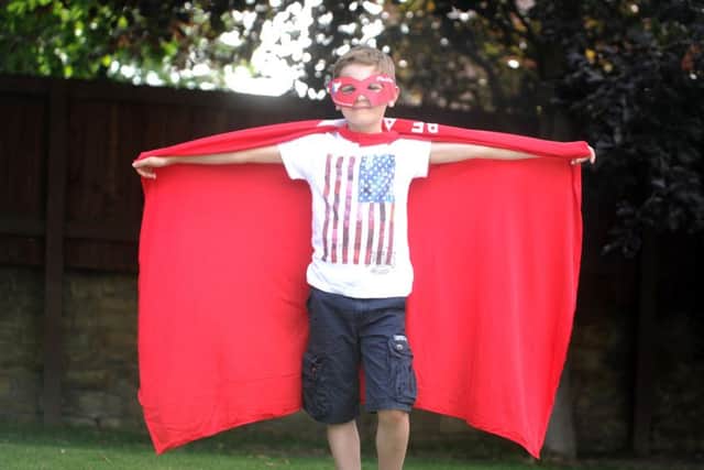 James Hodgson, nine, pictured at his home in Wakefield wearing the Be A Hero campaign cape. Picture by Simon Hulme.