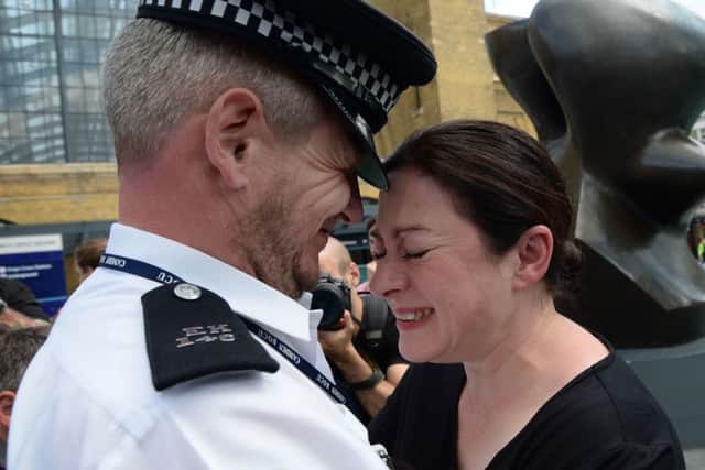7/7 survivor Gill Hicks hugs PC Andy Maxwell, who came to her aid when she was injured.