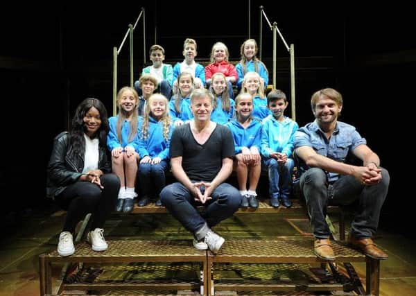 Jesus Christ Superstar performers Racel Adedeji, Glenn Carter and Tim Rogers with youngsters from The Stuart Stage School in Heckmondwike. Pic: James Hardisty.