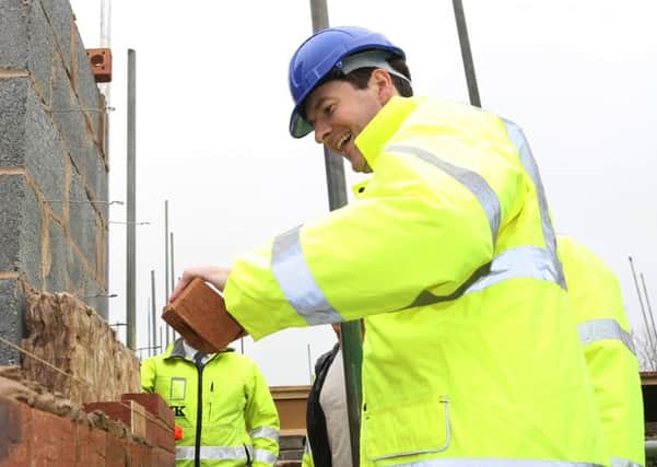 George Osborne laying bricks on visit to Morley