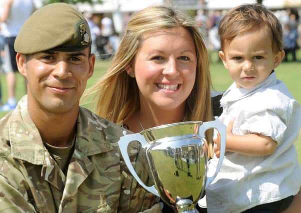 Private Bradley Addison from Leeds,  from the 1st Battalion Yorkshire Regiment  winner of the Best Soldier award at  the Great Yorkshire Show in Harrogate with his wife  Laura Addison and son Theo