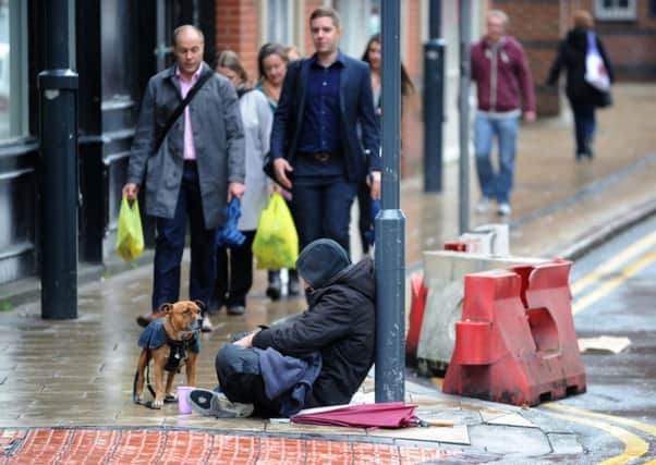 A beggar on Boar Lane in Leeds city centre. Picture: Jonathan Gawthorpe.