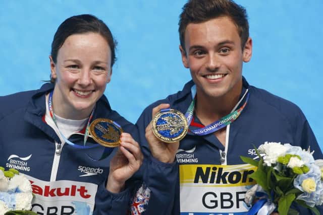 Britains Rebecca Galantree and Thomas Daley pose eith their gold medalsafter winning the Team Event diving final in Kazan. Picture: Sergei Grits/AP.
