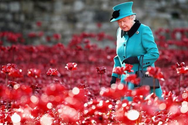 Queen Elizabeth II visits the Tower of London's Blood Swept Lands and Seas of Red installation in October 2014. 
Photo: Chris Jackson/PA Wire