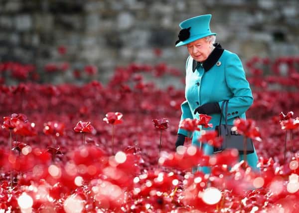 Queen Elizabeth II visits the Tower of London's Blood Swept Lands and Seas of Red installation in October 2014. 
Photo: Chris Jackson/PA Wire