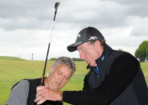 David Leadbetter, one of the worlds leading golf instructors, demonstrates to Chris Stratford the backswing element of the A Swing during his recent visit to the Leadbetter Golf Academy at the Leeds Golf Centre at Wike Ridg (Picture: Steve Riding).