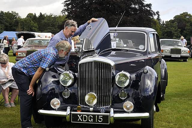 Visitors check under the bonnet of a 1955 Bentley R Type.