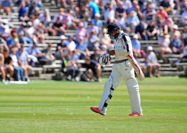 Yorkshires Adil Rashid trudges off, one of 20 wickets to fall on the opening day of the County Championship match at North Marine Road, Scarborough against Durham (Picture: Tony Johnson).