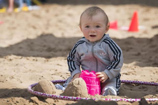 One year old Michael Wrigglesworth, from East End Park, having fun in the sand.