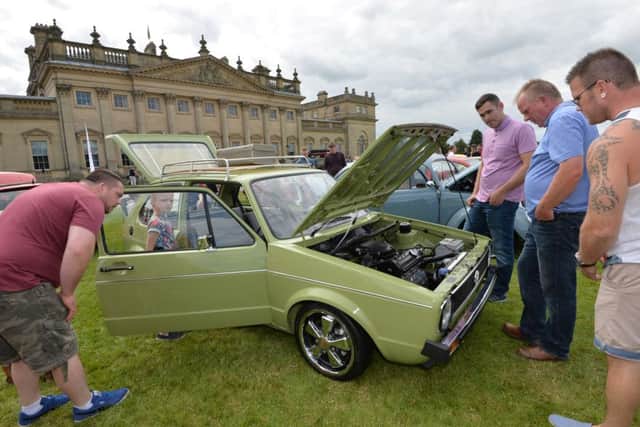 Enthusiasts look at a 1981 VW Golf Mark One during the VW Festival at Harewood House. Picture: Anna Gowthorpe