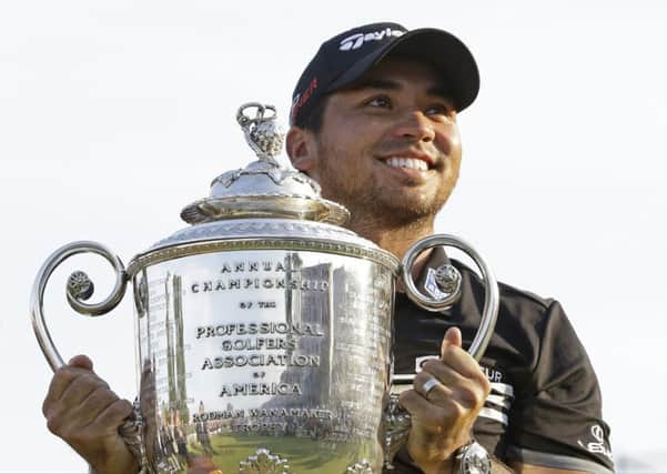 Australian Jason Day smiles as he holds up the Wanamaker Trophy after winning the US PGA Championship