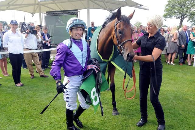 Date:19th August 2015. Picture James Hardisty (JH1009/94o)Welcome to Yorkshire York Races Ebor Festival 2015. Pictured Silvestre De Sousa, next to Arabian Queen, winner of The Juddmonte International Stakes in the parade ring after the race.