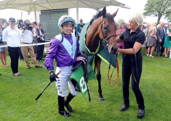 Date:19th August 2015. Picture James Hardisty (JH1009/94o)
Welcome to Yorkshire York Races Ebor Festival 2015. Pictured Silvestre De Sousa, next to Arabian Queen, winner of The Juddmonte International Stakes in the parade ring after the race.