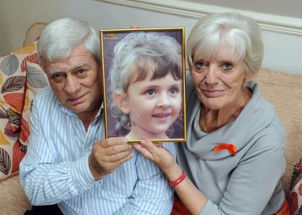 Paul and Marilyn Dunford, from Rodley, with a picture of their granddaughter Yanna, four. Picture by James Hardisty.