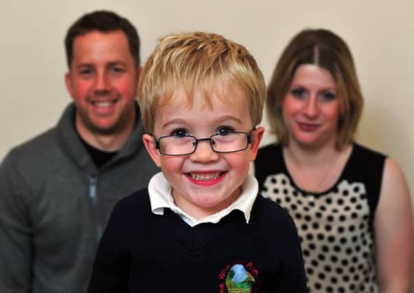 Sam Brown, 6,  with  parents Katy and Simon from Otley.